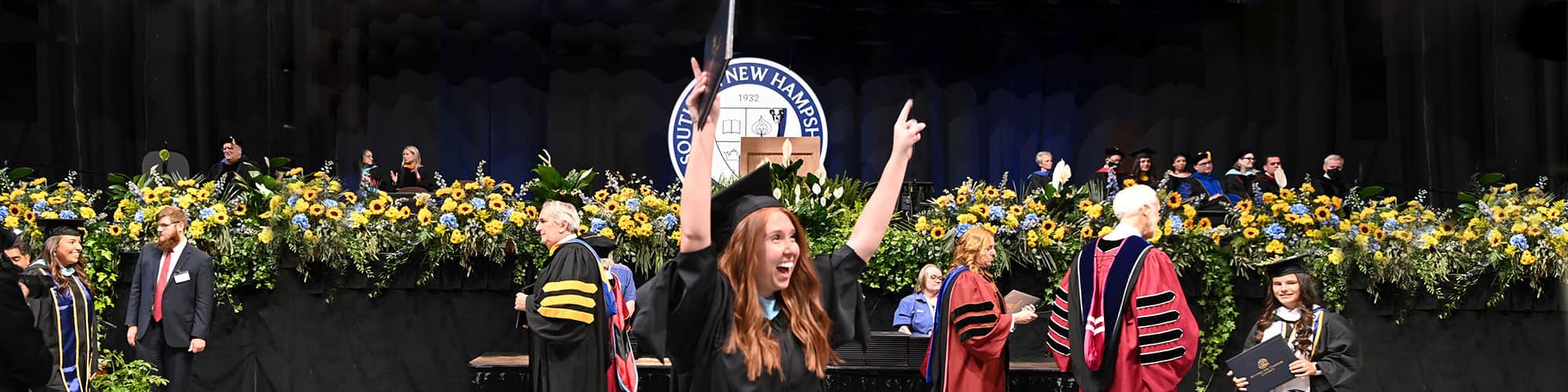 A SNHU graduate celebrating at commencement