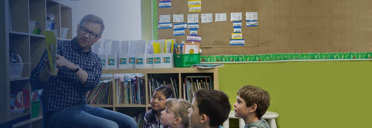 Educator in the classroom reading to children